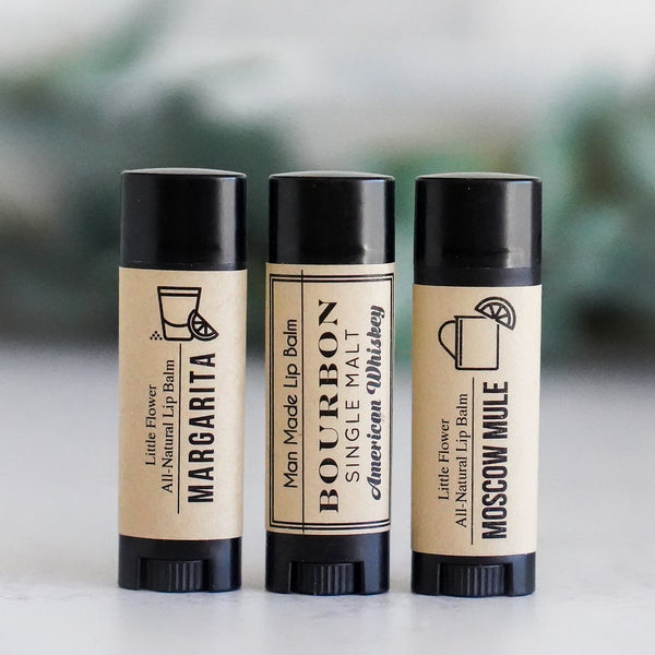 manly looking lip balm chapsticks in margarita, bourbon whiskey and Moscow mule flavors in black oval tubes with Kraft labels and black printing featuring icons of tequila, limes and a mule mug natural and man made for gifts for men