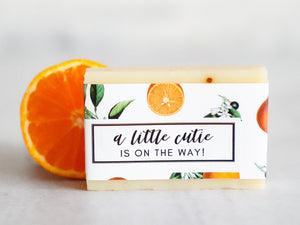 handmade soap with a little cutie is on the way label for baby shower or pregnancy announcement small gift featuring watercolor oranges on a small bar of artisan homemade soap.