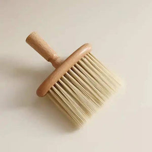 Wooden brush with bristle head on a light beige background