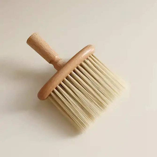 Wooden brush with bristle head on a light beige background