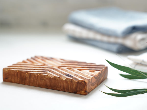 olive wood soap dish self draining with modern ikat carvings on a farmhouse bathroom counter top 