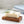 Load image into Gallery viewer, A bar of handmade soap on a gorgeous olive wood hand-carved soap dish a sprig of olive on top and some linen hand towels behind in a brightly lit bathroom
