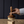 Load image into Gallery viewer, Hand holding the luxe b. high end wooden dish washing brush over a block of soap on a wooden surface with a dark background
