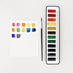 Watercolor paint set by emily lex studio 12 color tin with size 6 brush and mixing pallet lid.  for learning to watercolor paint.