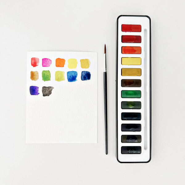 Watercolor paint set by emily lex studio 12 color tin with size 6 brush and mixing pallet lid.  for learning to watercolor paint.